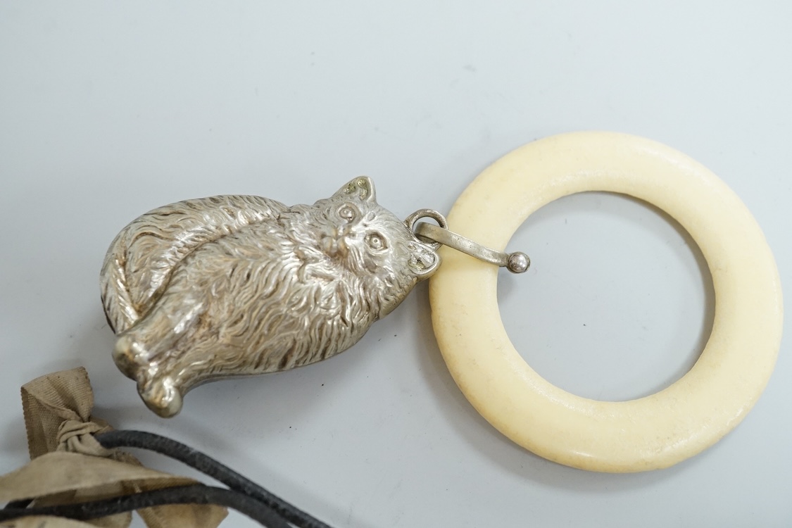 A George V silver circular vesta case, S. Blanckensee & Son Ltd, Birmingham, 43mm, together with a damaged silver child's rattle by George Unite, a cat child's rattle, white metal and lapis lazuli set fob, etc.